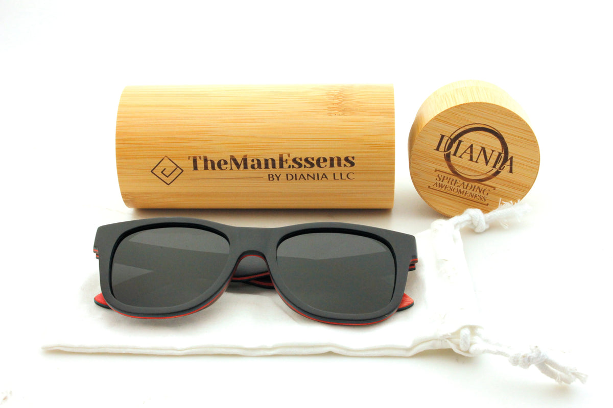 Penya-Roja black skateboard wooden sunglasses on cotton bag in front of bamboo tube case