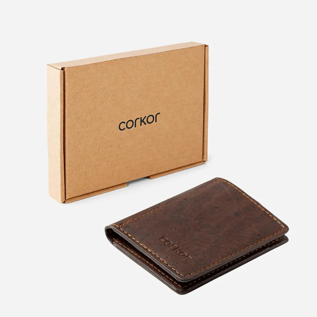 Brown slim cork coin wallet next to its box