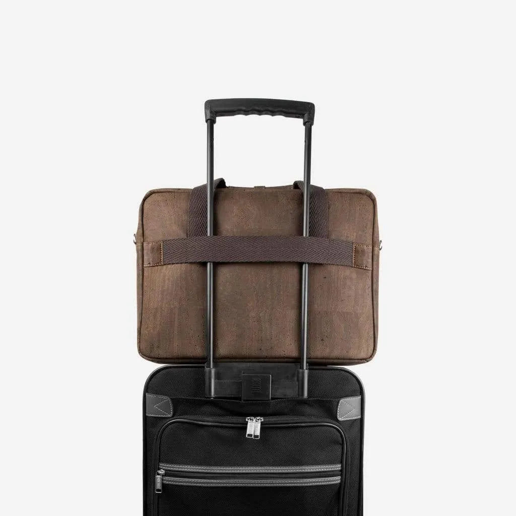 Brown cork briefcase on a suitcase handle using the back trolley sleeve