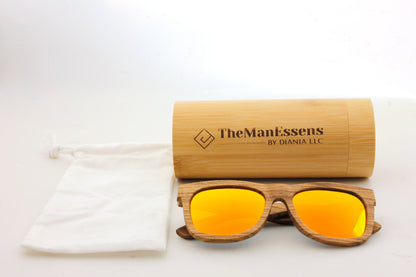 Carrasqueta zebra wood sunglasses next to cotton bag in front of bamboo cilinder case