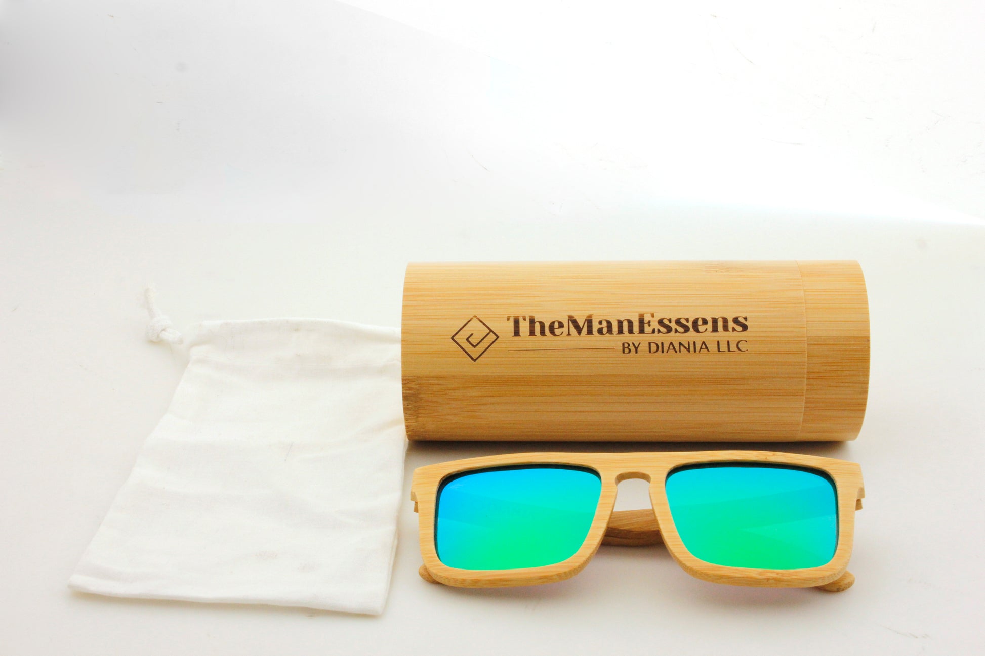 Teixereta bamboo wood sunglasses next to cotton bag in front of bamboo tube case