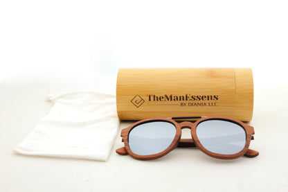 Barcella Bubinga wood sunglasses next to cottong bab and in front of bamboo cilinder case