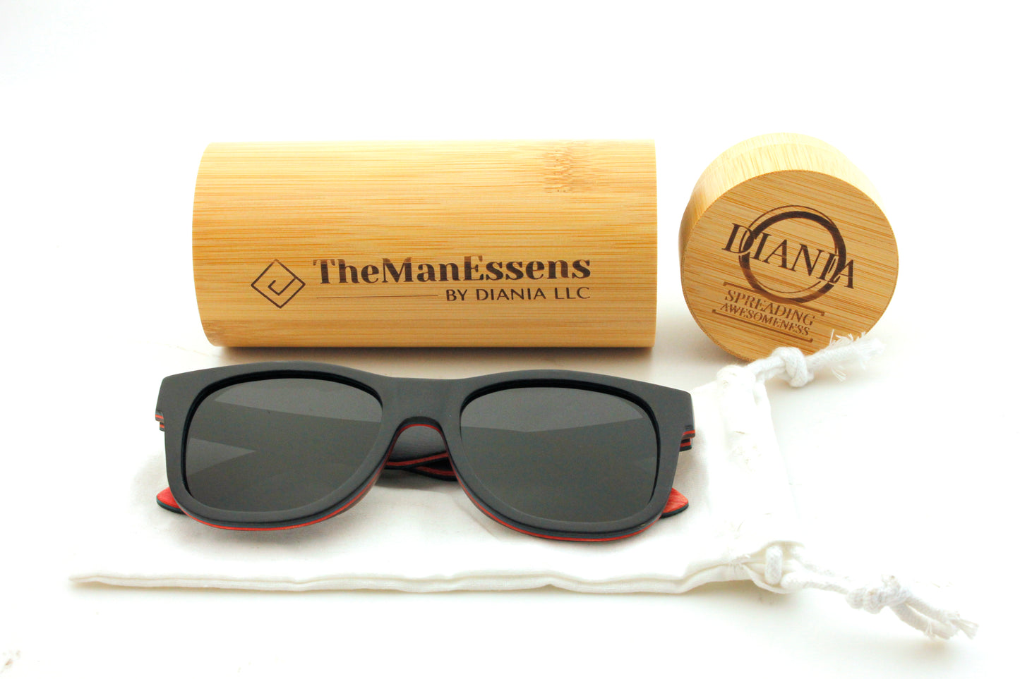 Penya-Roja black skateboard wooden sunglasses on cotton bag in front of bamboo tube case