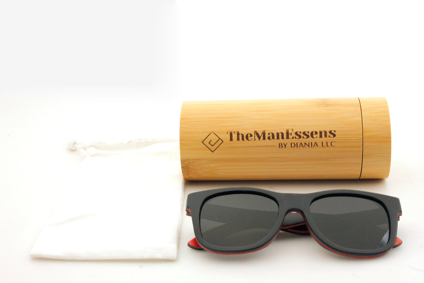 Penya-Roja black skateboard wooden sunglasses on cotton bag next of bamboo tube case