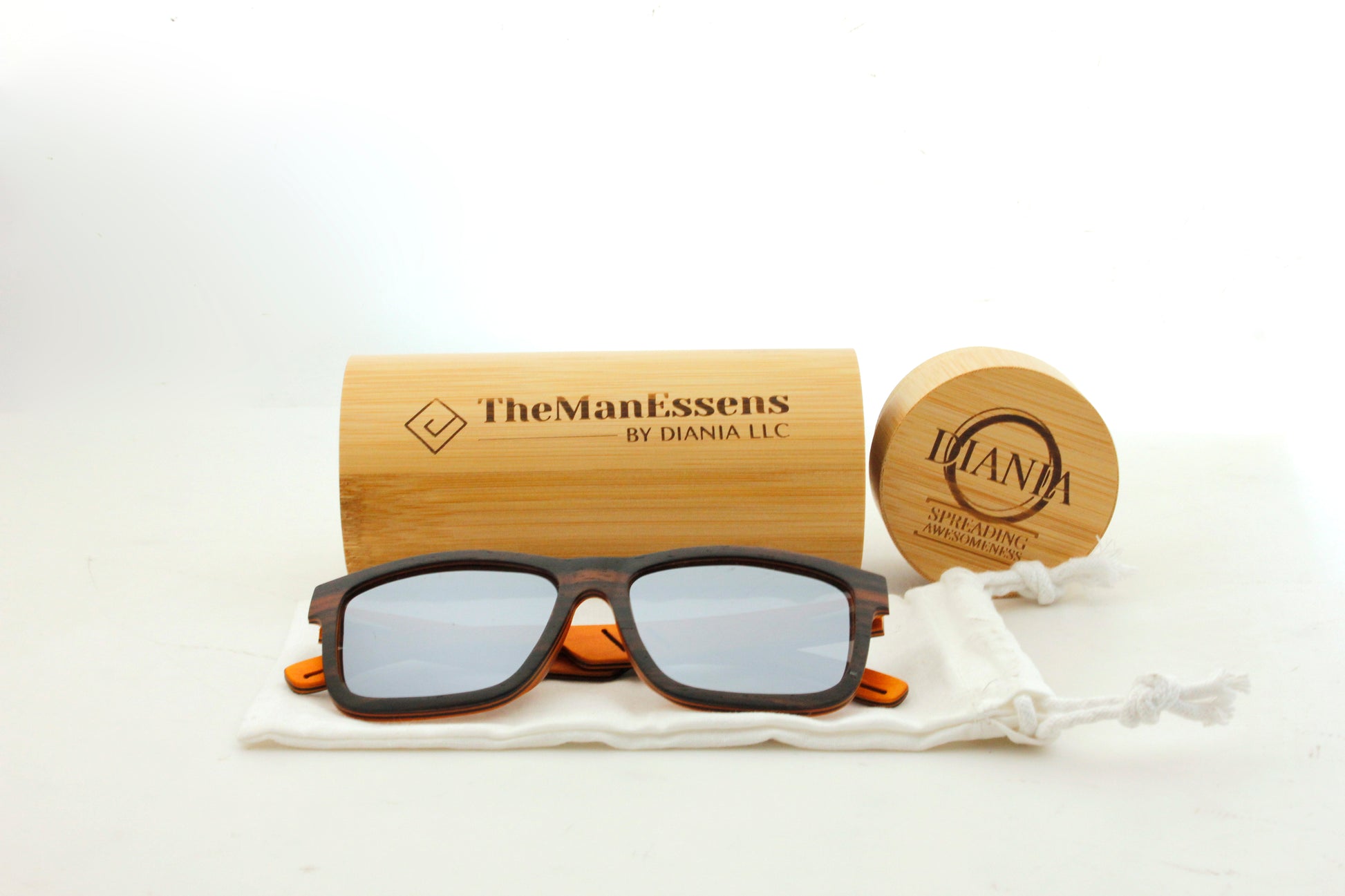 Aitana black laminated wood sunglasses on cotton bag and in front of bamboo case