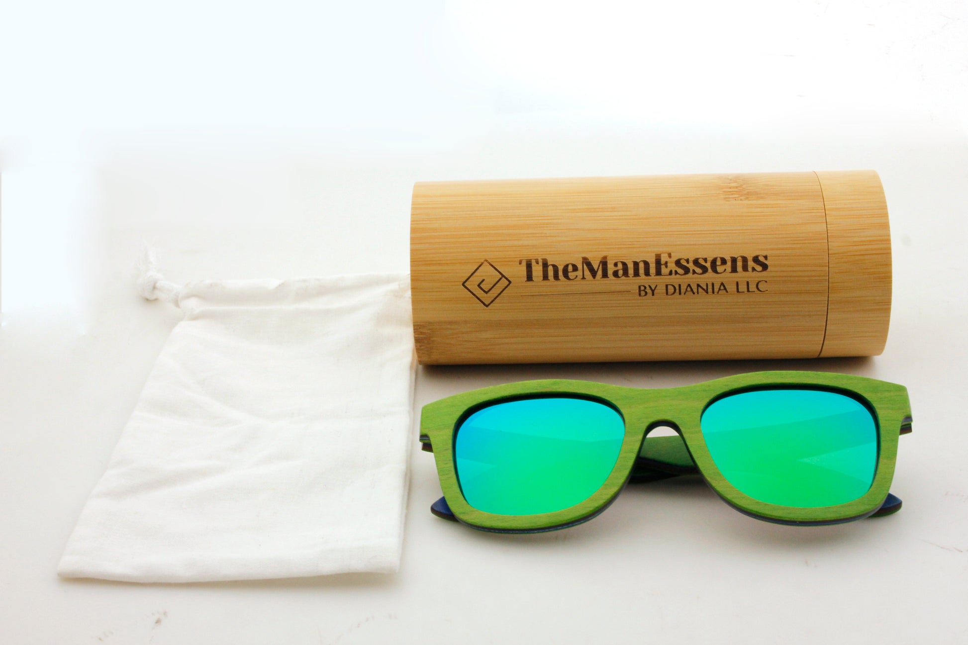 Quarter bamboo wood sunglasses next to cotton bag in front of bamboo tube case