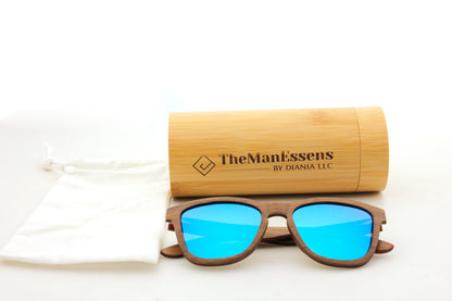 Menejador Layered Walnut Wood Sunglasses next to cotton back in front of bamboo cilinder case