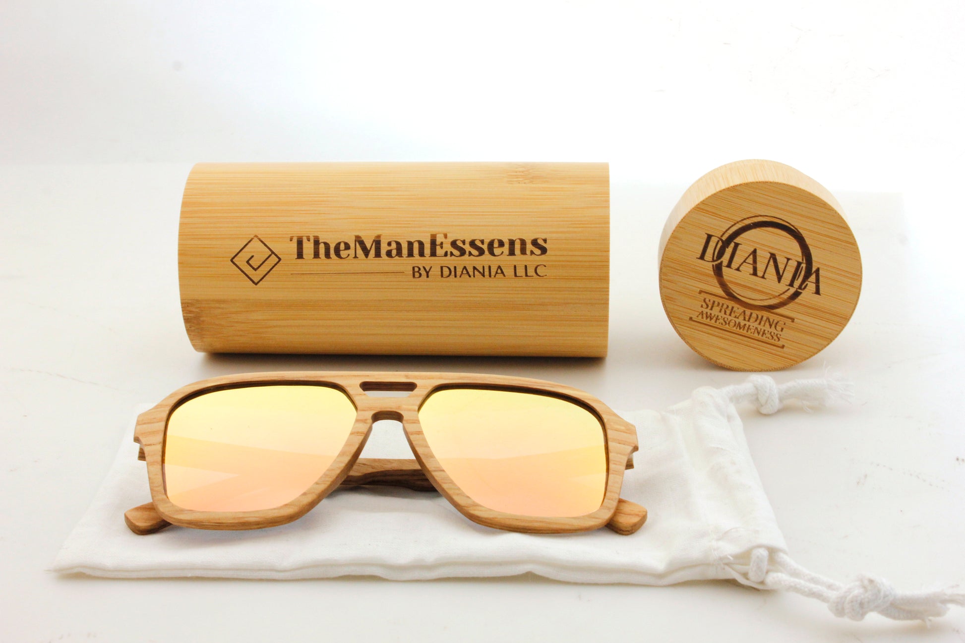 Bèrnia layered oak wood sunglasses on cotton bag and in front of bamboo  cilinder case
