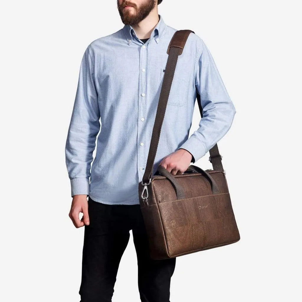 Man carrying the brown cork briefcase on its shoulder strap