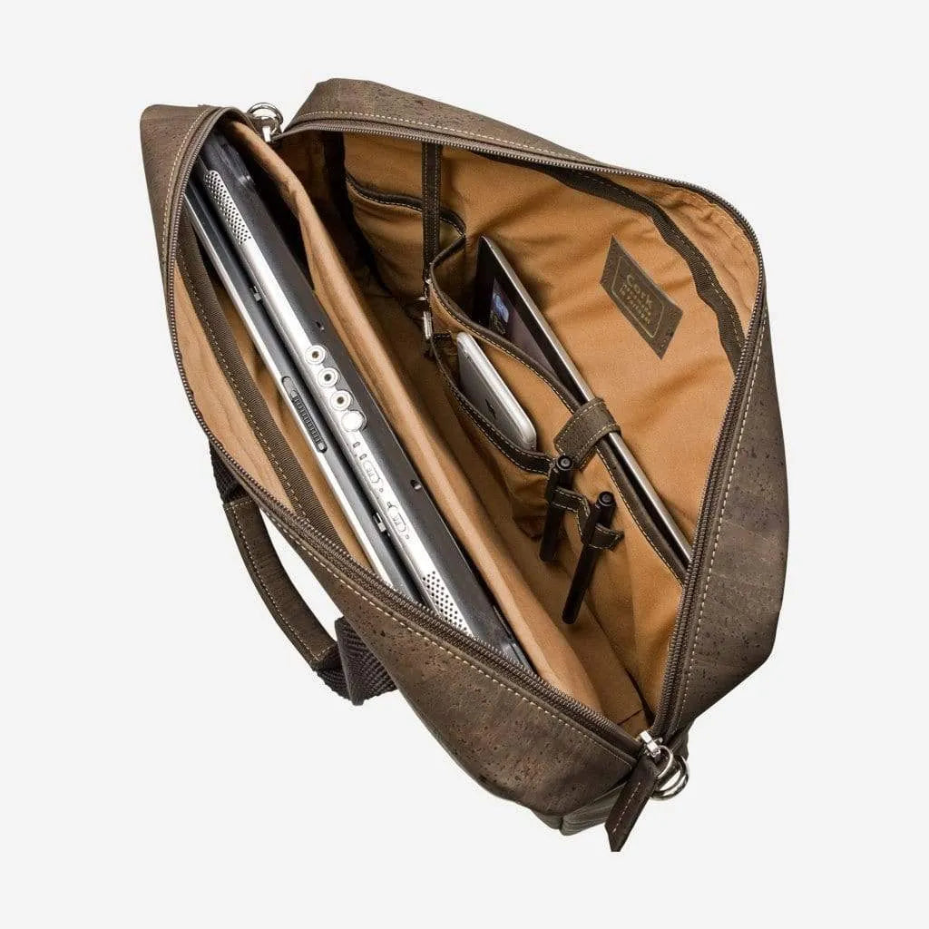 Brown cork briefcase open, showing the padded laptop pocket and inside pockets